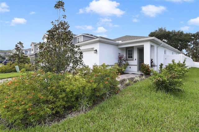 view of front of house featuring a front yard and a garage