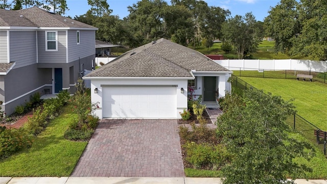 view of front of home featuring a garage and a front lawn