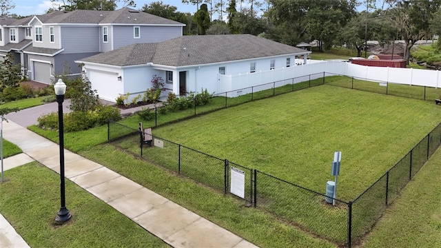 view of community featuring a lawn and a garage