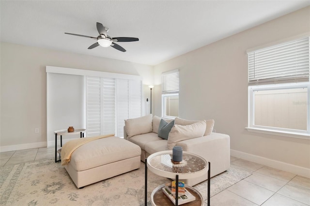 living room featuring ceiling fan and light tile patterned floors