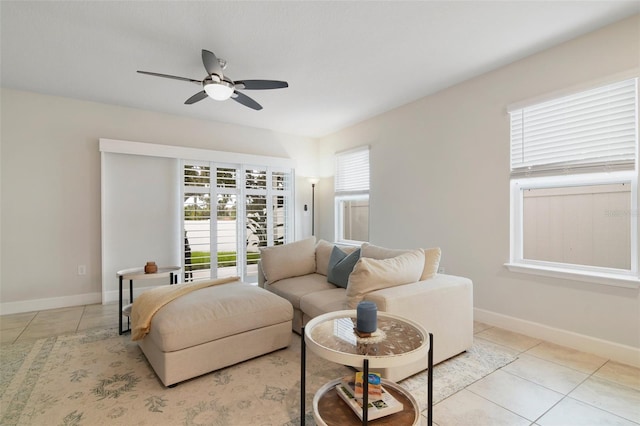 living room with ceiling fan and light tile patterned floors