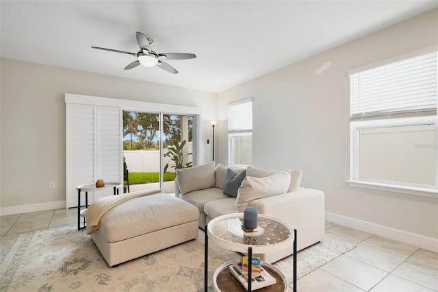 living room featuring ceiling fan and light tile patterned flooring