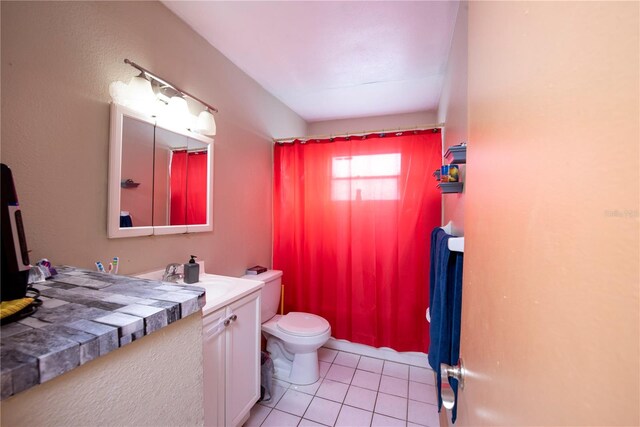 bathroom with vanity, toilet, and tile patterned flooring