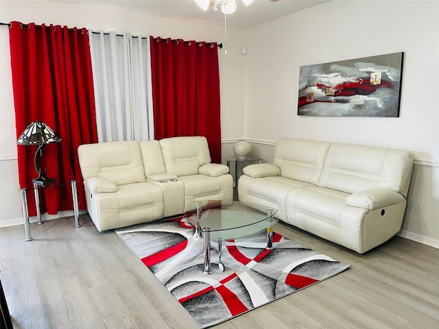 living room featuring ceiling fan and light wood-type flooring