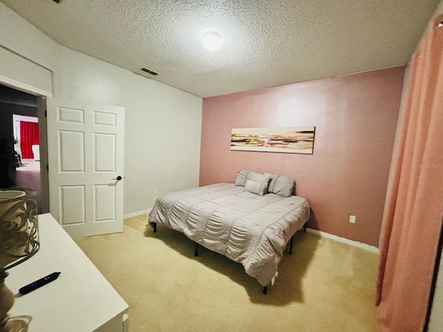 carpeted bedroom with a textured ceiling