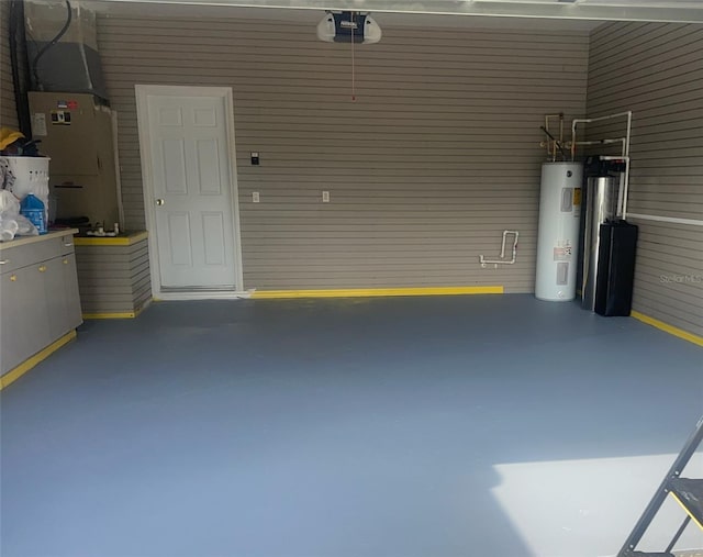 garage with a garage door opener and electric water heater