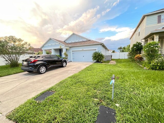 view of front facade with a yard and a garage