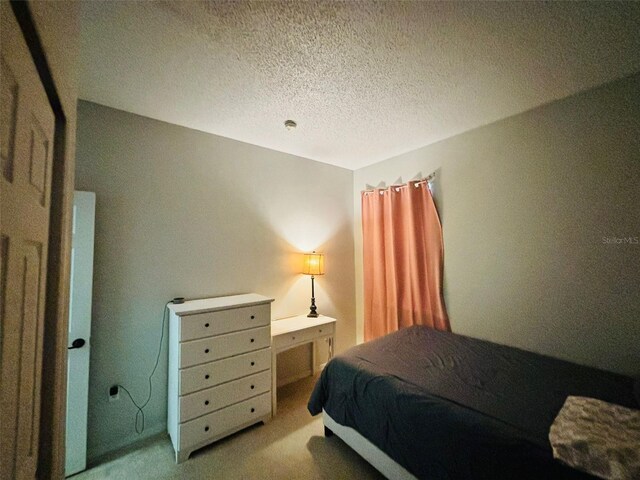 carpeted bedroom with a textured ceiling