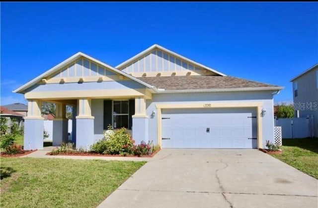 craftsman house with a garage and a front yard