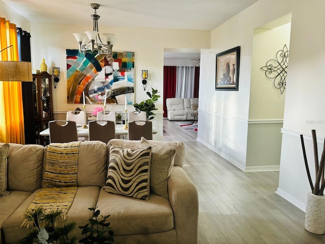 living room with a notable chandelier and hardwood / wood-style floors