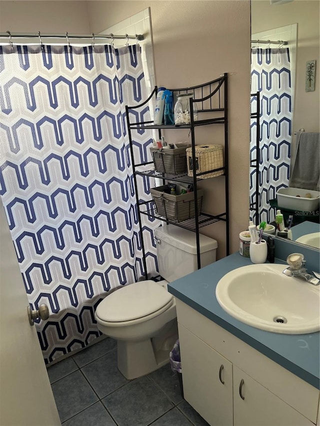 bathroom featuring tile patterned floors, a shower with curtain, vanity, and toilet