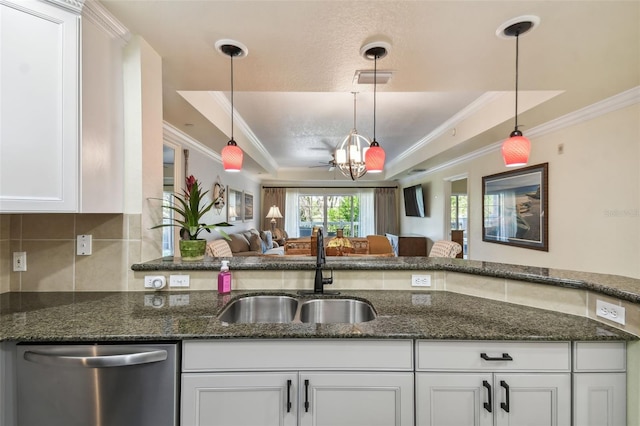 kitchen with dishwasher, hanging light fixtures, sink, and white cabinetry