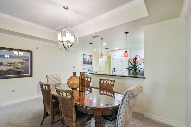 carpeted dining space featuring sink, a tray ceiling, crown molding, and a chandelier