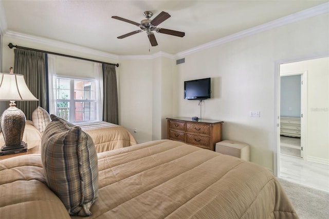 carpeted bedroom with ceiling fan and crown molding