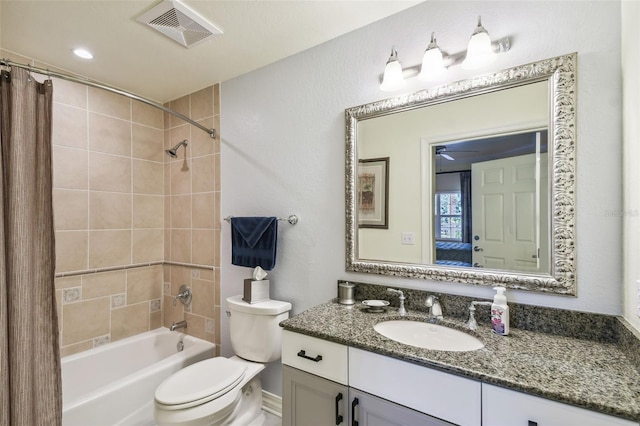 full bathroom featuring shower / tub combo with curtain, vanity, and toilet