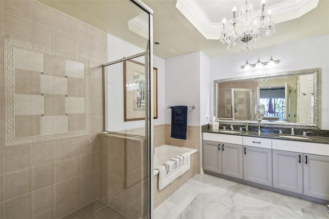 bathroom with vanity, a tray ceiling, shower with separate bathtub, ornamental molding, and a chandelier