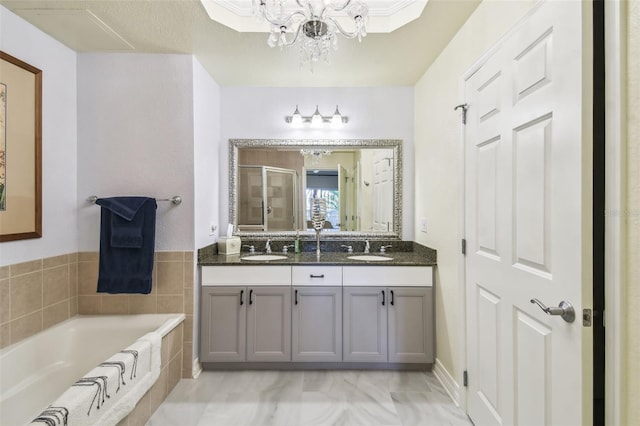 bathroom with independent shower and bath, vanity, and a notable chandelier