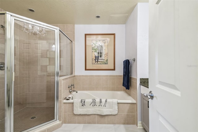 bathroom featuring independent shower and bath, a textured ceiling, and tile patterned flooring