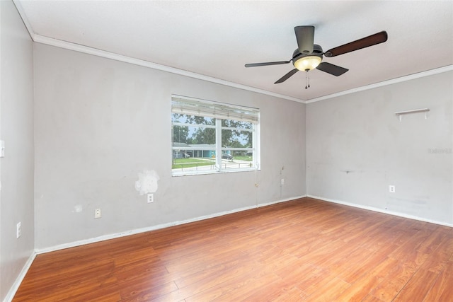 empty room featuring ceiling fan, ornamental molding, and wood-type flooring