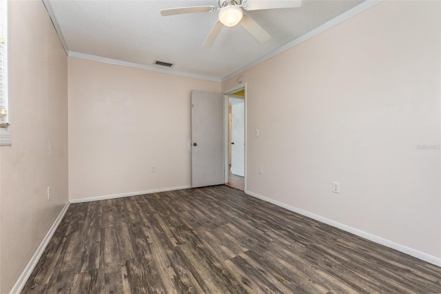 unfurnished room featuring ornamental molding, ceiling fan, and dark wood-type flooring