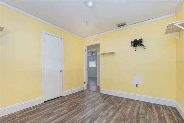 unfurnished room with crown molding, dark hardwood / wood-style floors, and ceiling fan