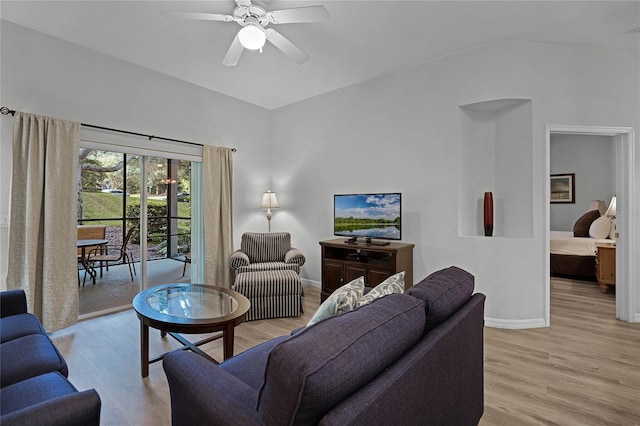 living room featuring ceiling fan and light hardwood / wood-style floors