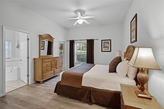 bedroom with ceiling fan, light hardwood / wood-style floors, and ensuite bathroom