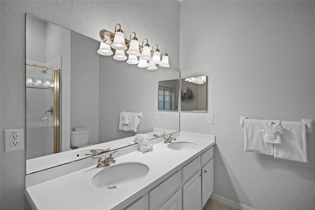 bathroom with walk in shower, vanity, and toilet