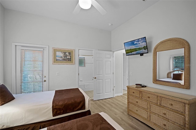 bedroom featuring multiple windows, light wood-type flooring, ensuite bath, and ceiling fan