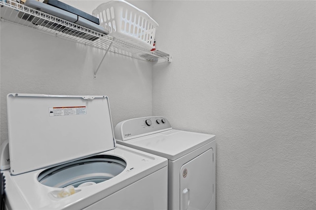 clothes washing area with washing machine and clothes dryer