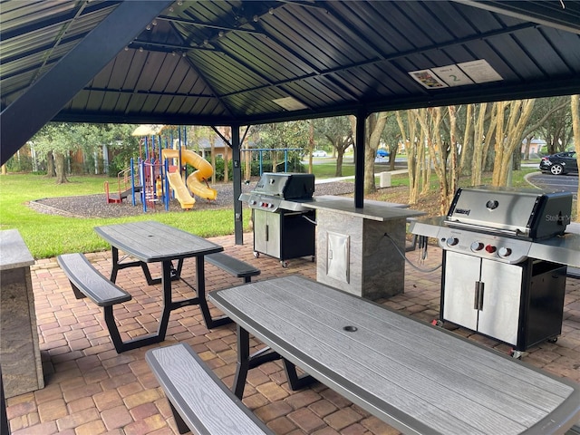 306 Lucaya Loop Unit B5/U306, Davenport, FL 33897 - view of patio / terrace with grilling area and playground community