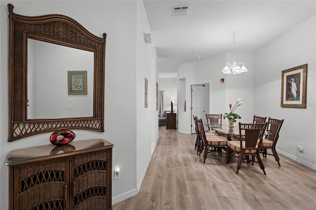 dining room featuring a chandelier and light hardwood / wood-style floors