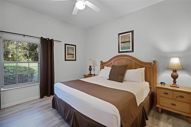 bedroom featuring light wood-type flooring and ceiling fan