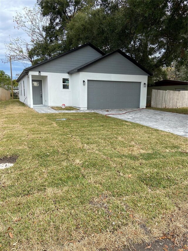 view of front of home featuring a front yard and a garage