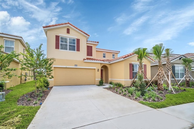 mediterranean / spanish house with a garage and a front lawn