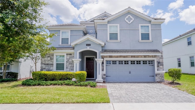 1676 Moon Valley Dr, Davenport, FL 33896 - traditional-style house with stone siding, decorative driveway, an attached garage, and a front lawn