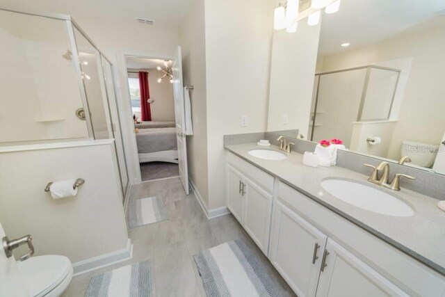 bathroom with a shower stall, visible vents, and a sink