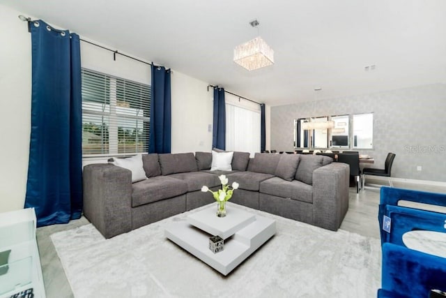 living area featuring visible vents, a healthy amount of sunlight, and wallpapered walls