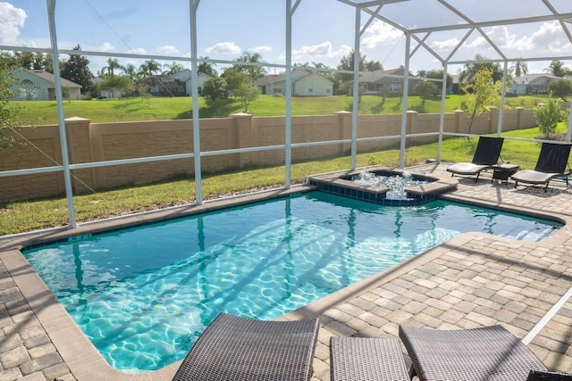 view of pool with glass enclosure, a residential view, a lawn, and a patio area