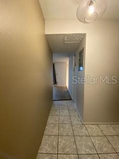 hallway with tile patterned floors