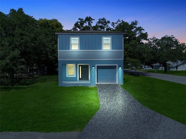 view of front facade featuring a lawn and a garage