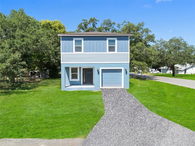 view of front facade with a garage and a front lawn