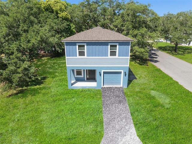 view of front of house featuring a garage and a front lawn