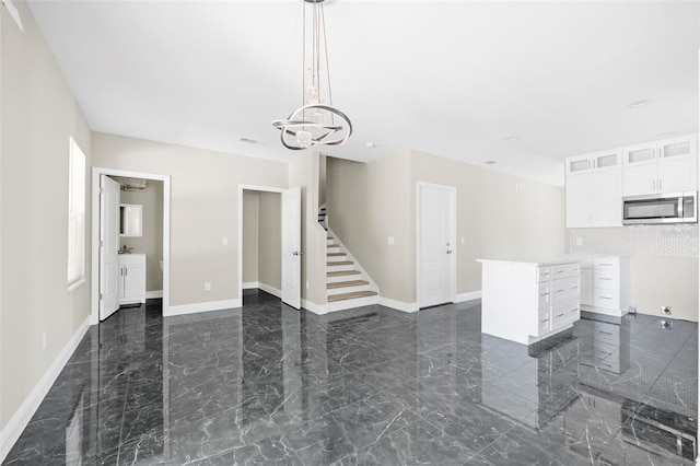 unfurnished living room with a chandelier