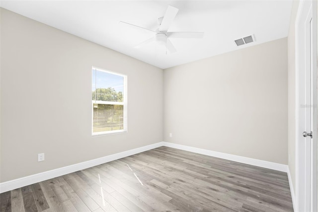 unfurnished room with ceiling fan and hardwood / wood-style flooring