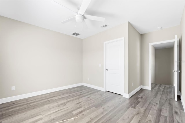 unfurnished room with ceiling fan and light hardwood / wood-style flooring