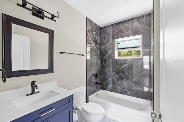 full bathroom featuring tiled shower / bath combo, vanity, and toilet