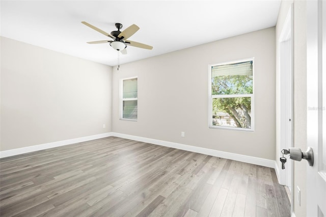 spare room featuring light wood-type flooring and ceiling fan