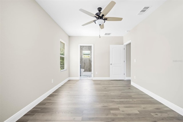 spare room with ceiling fan and light hardwood / wood-style floors