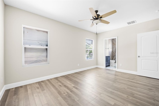 unfurnished bedroom with ceiling fan, connected bathroom, and light hardwood / wood-style floors